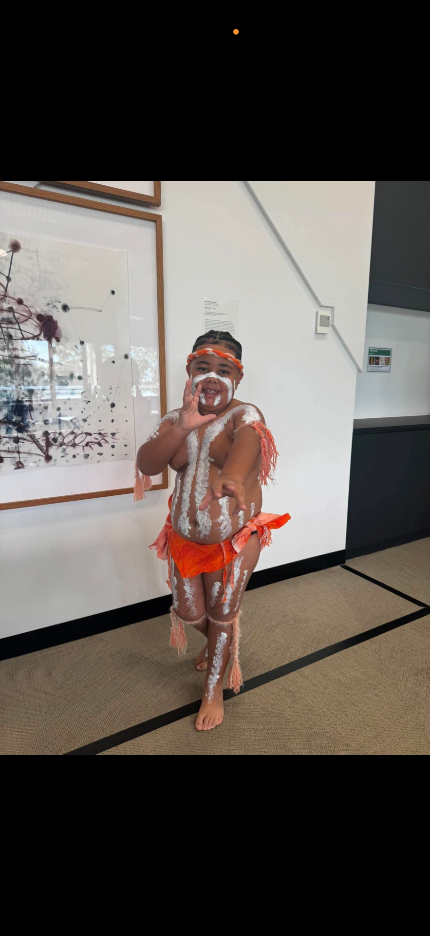 Aboriginal Elder holding the Aboriginal flag